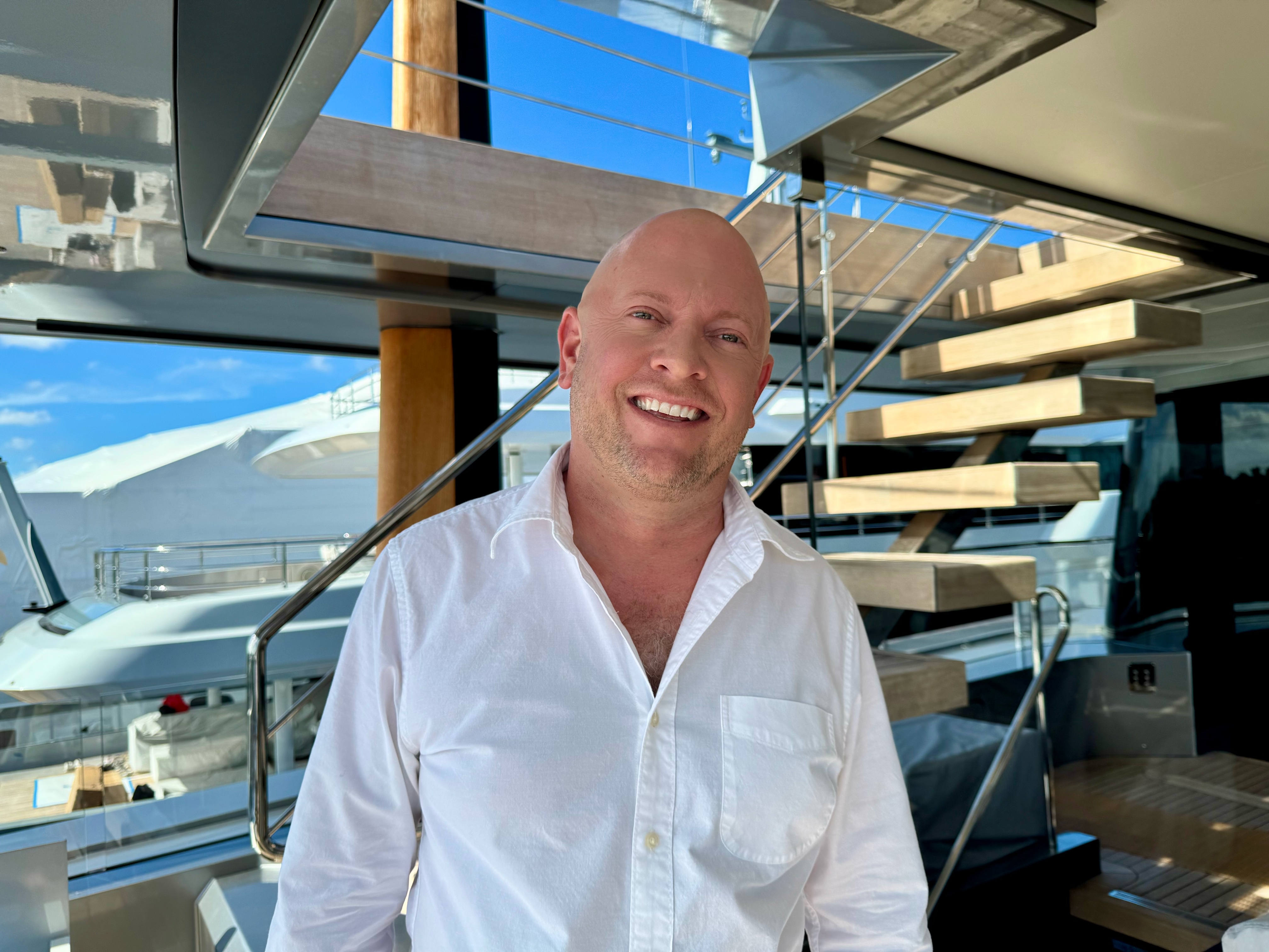 Captain Eli Olive standing on a yacht